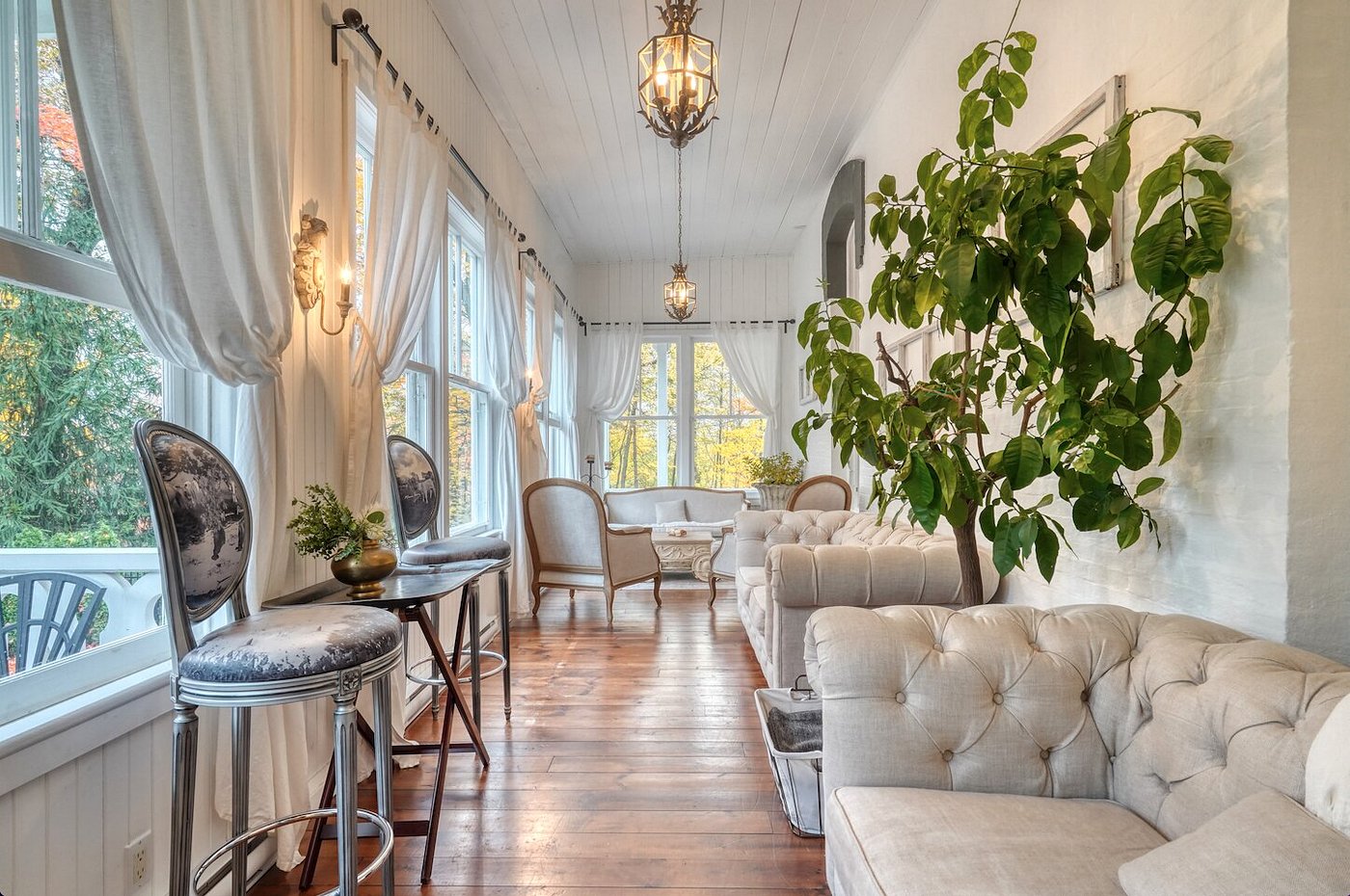 Bright sunroom with elegant furnishings and flowing curtains